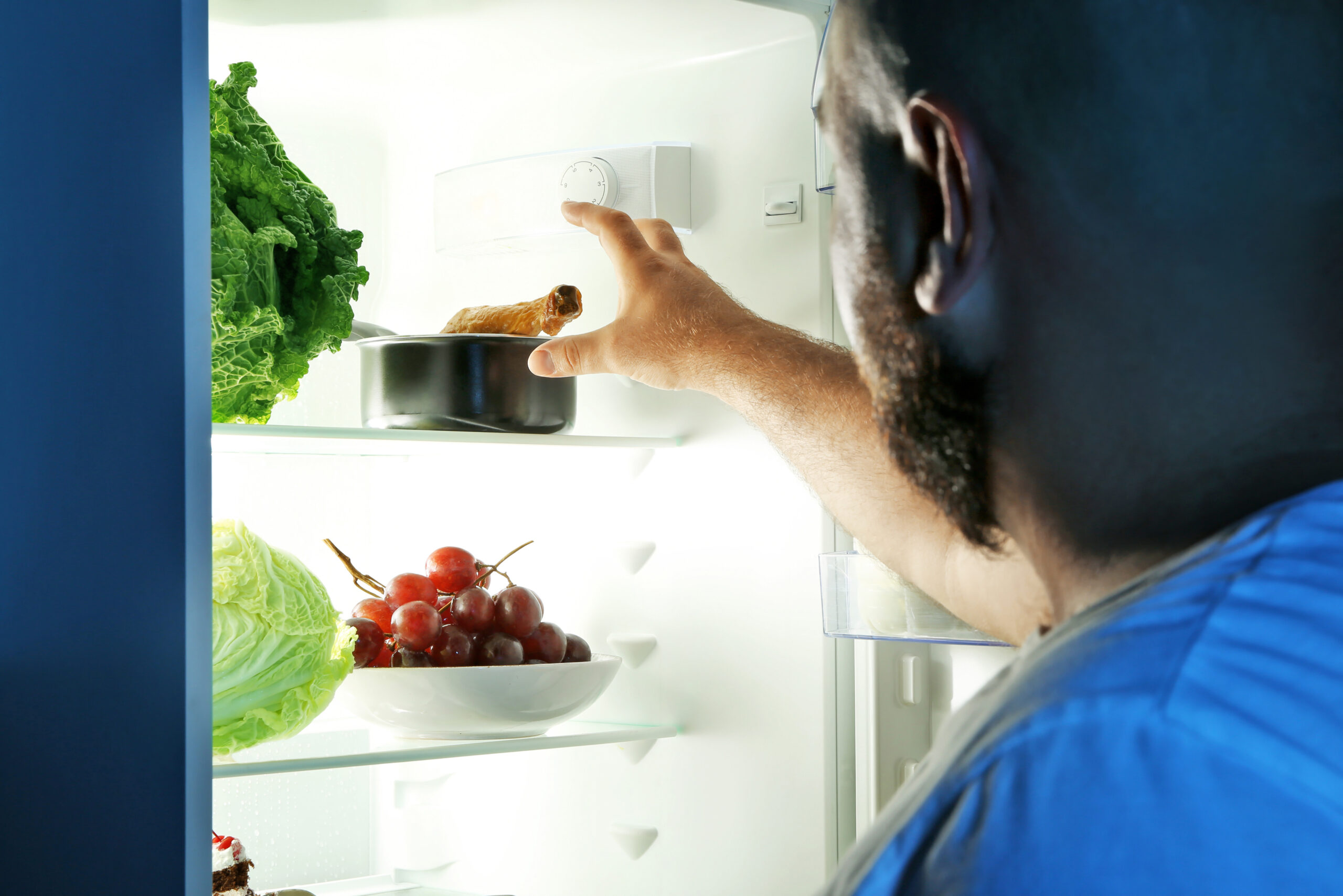 Man taking food from refrigerator