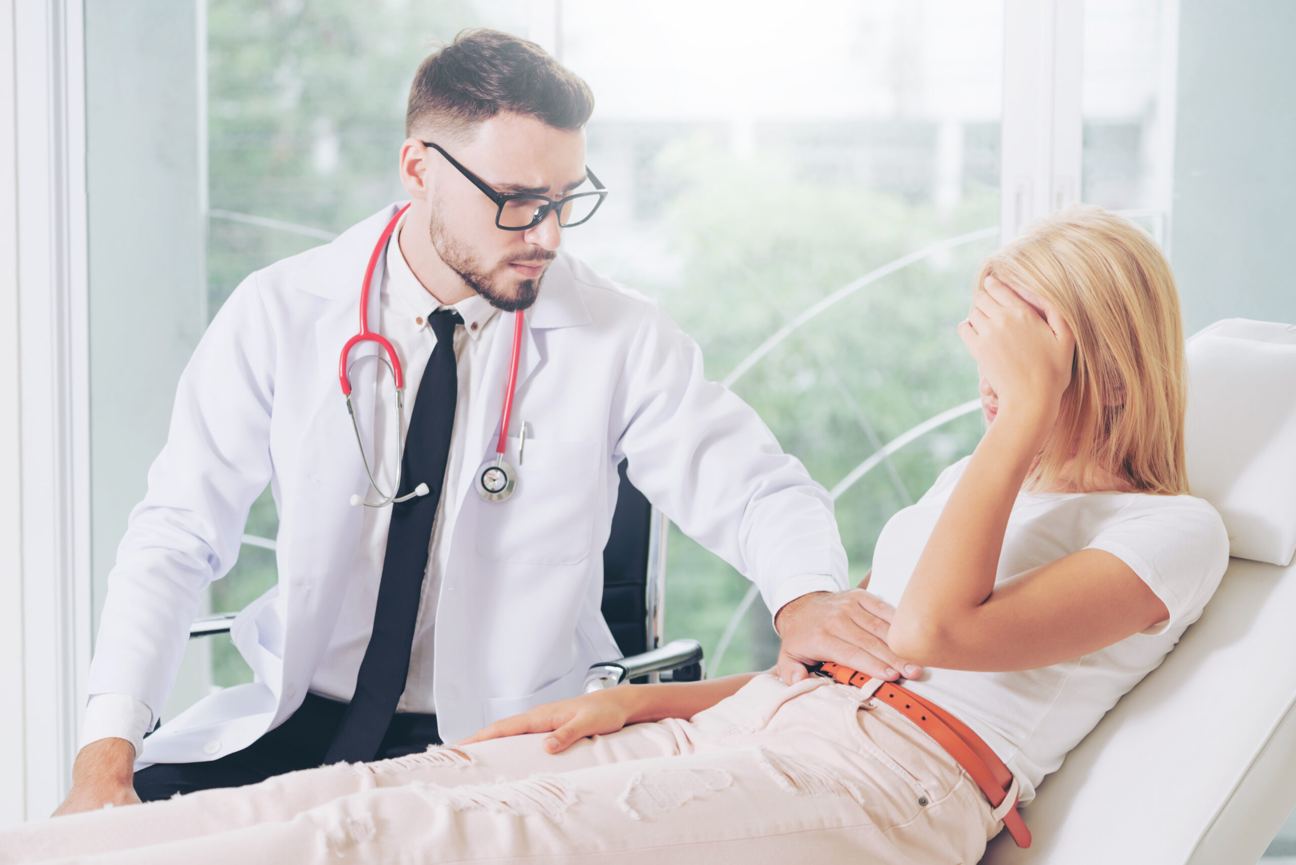 Male Doctor and Female Patient in Hospital Office