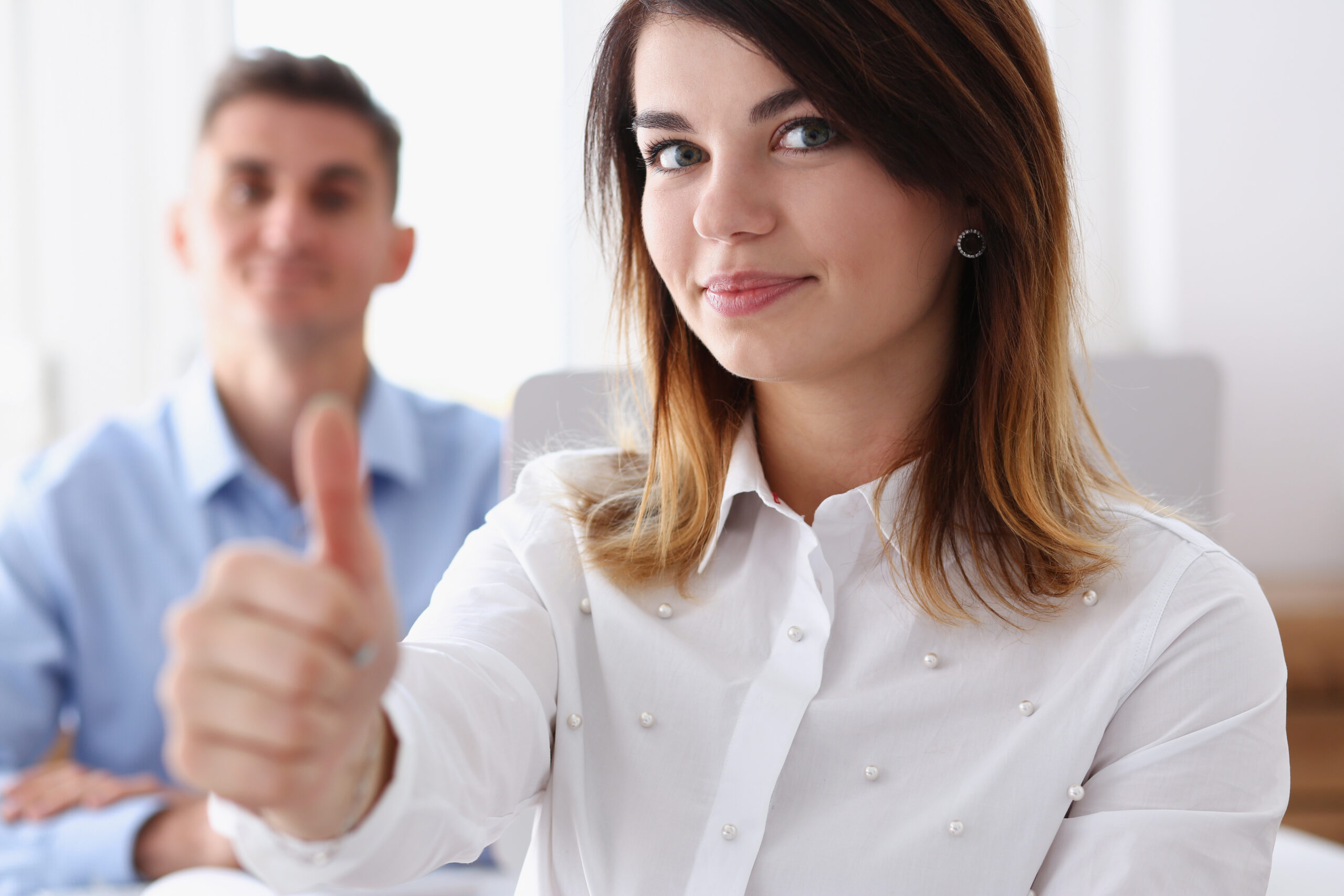 Female doing thumbs up at work