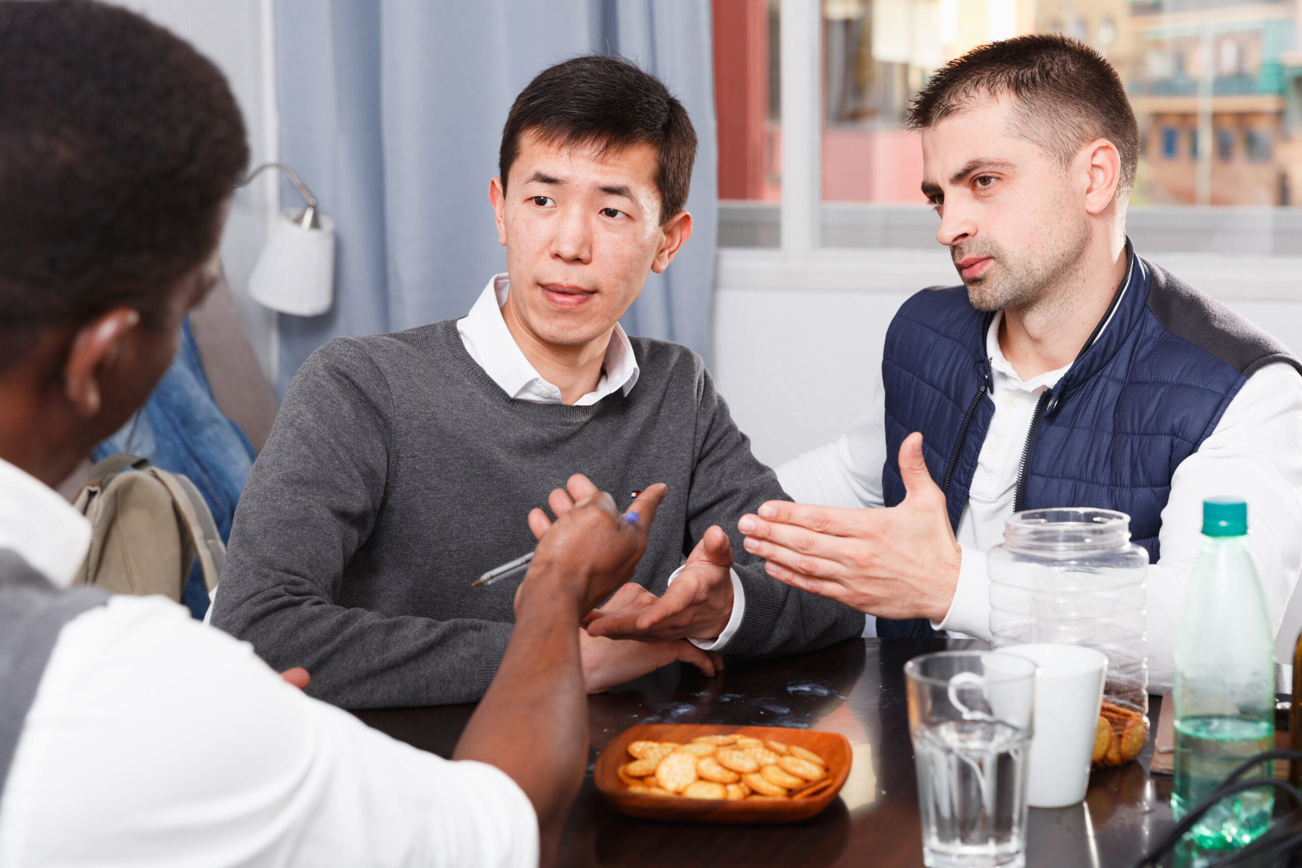 Three men are drinking beer and arguing in time rest together