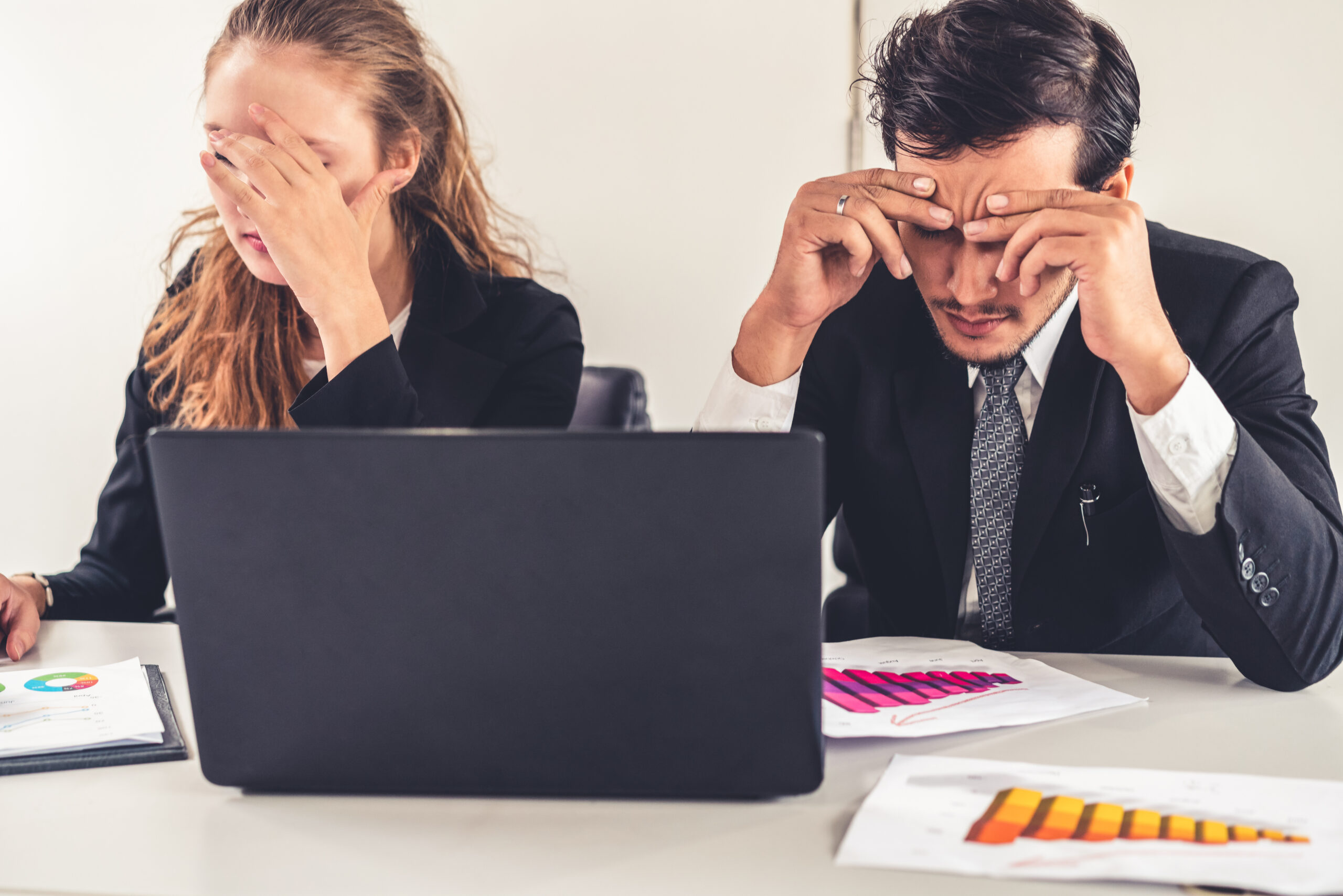 Unhappy serious businessman and businesswoman