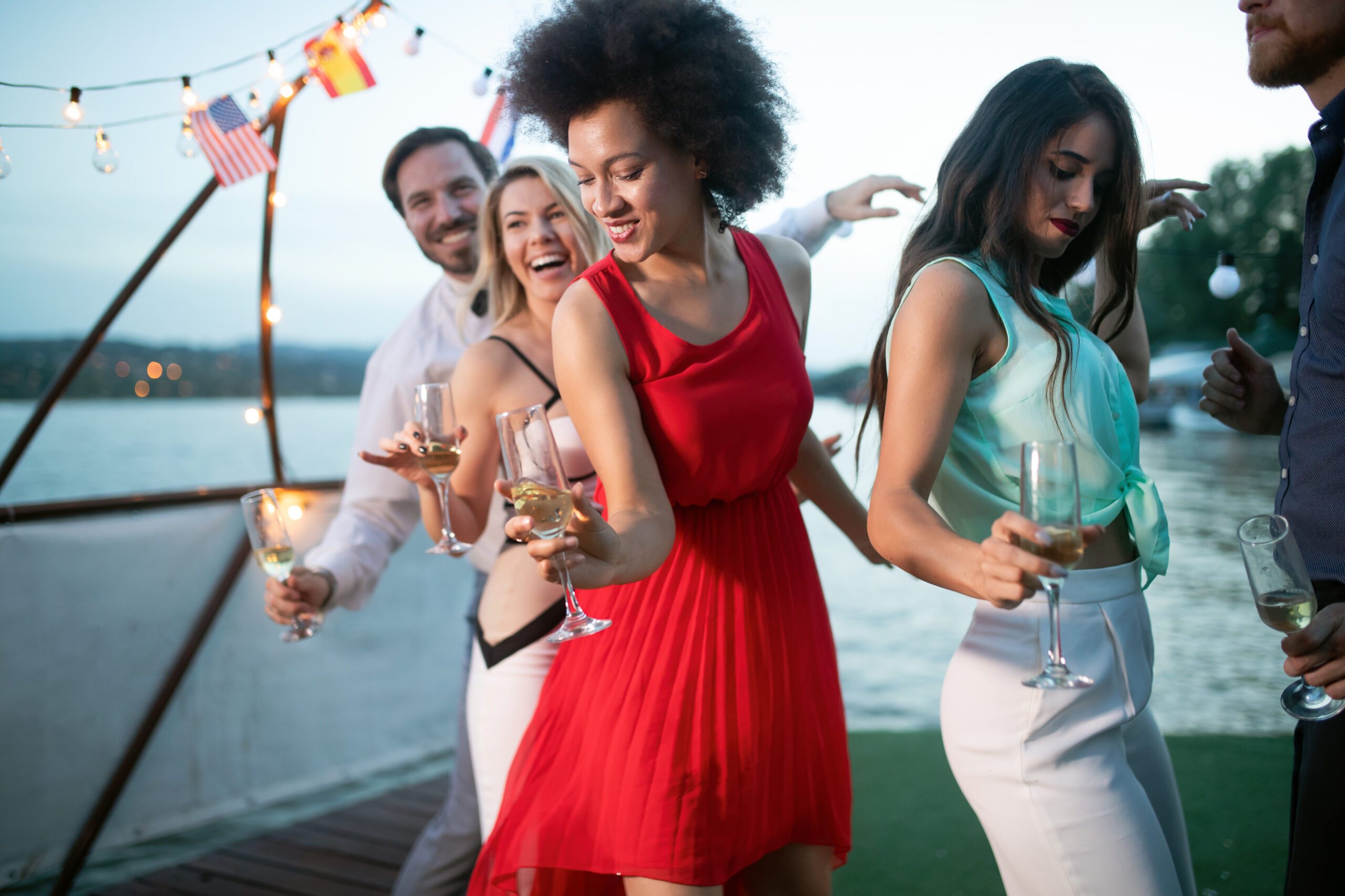 Group of friends at party dancing and smiling together