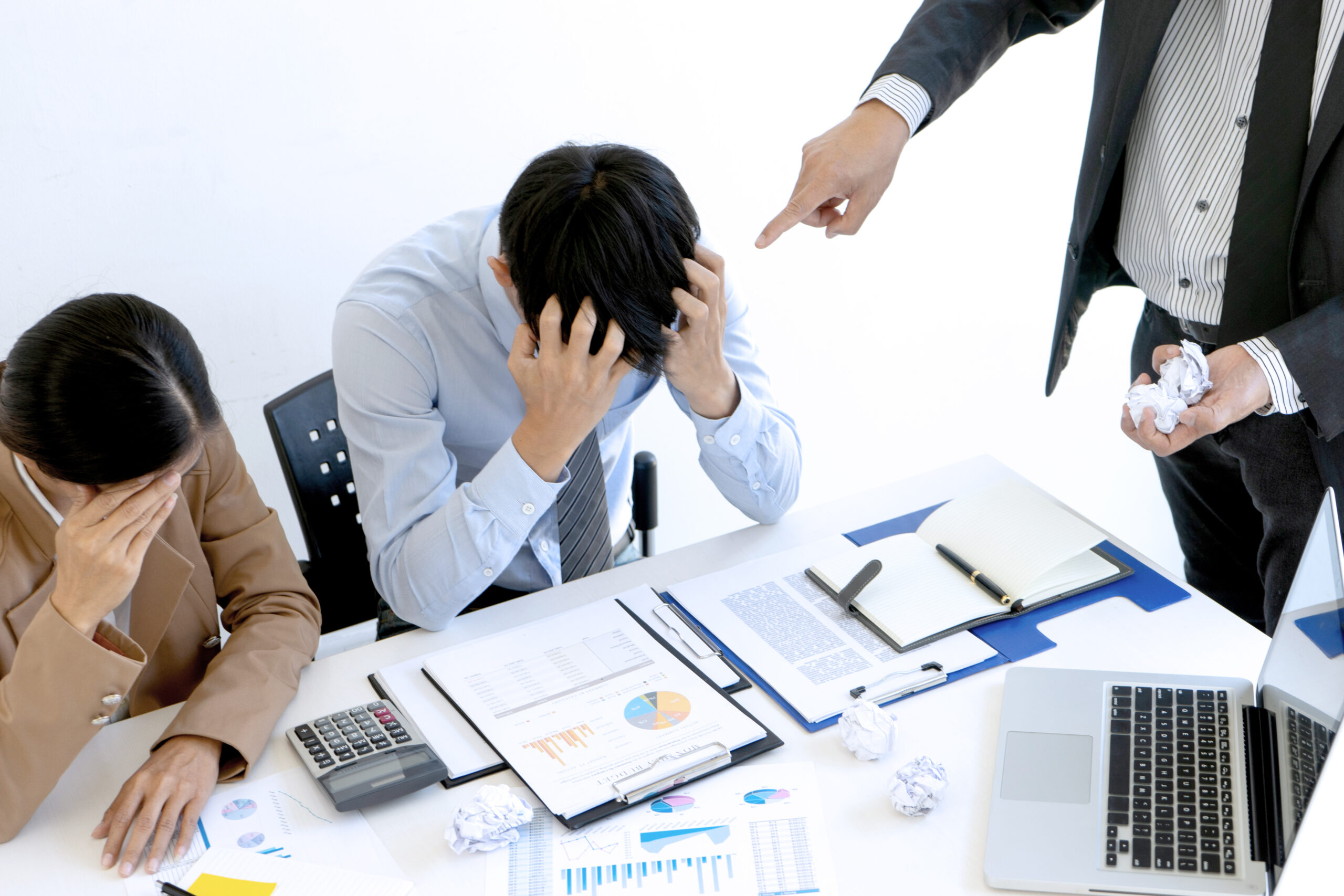 Angry boss shouting at distressed employee