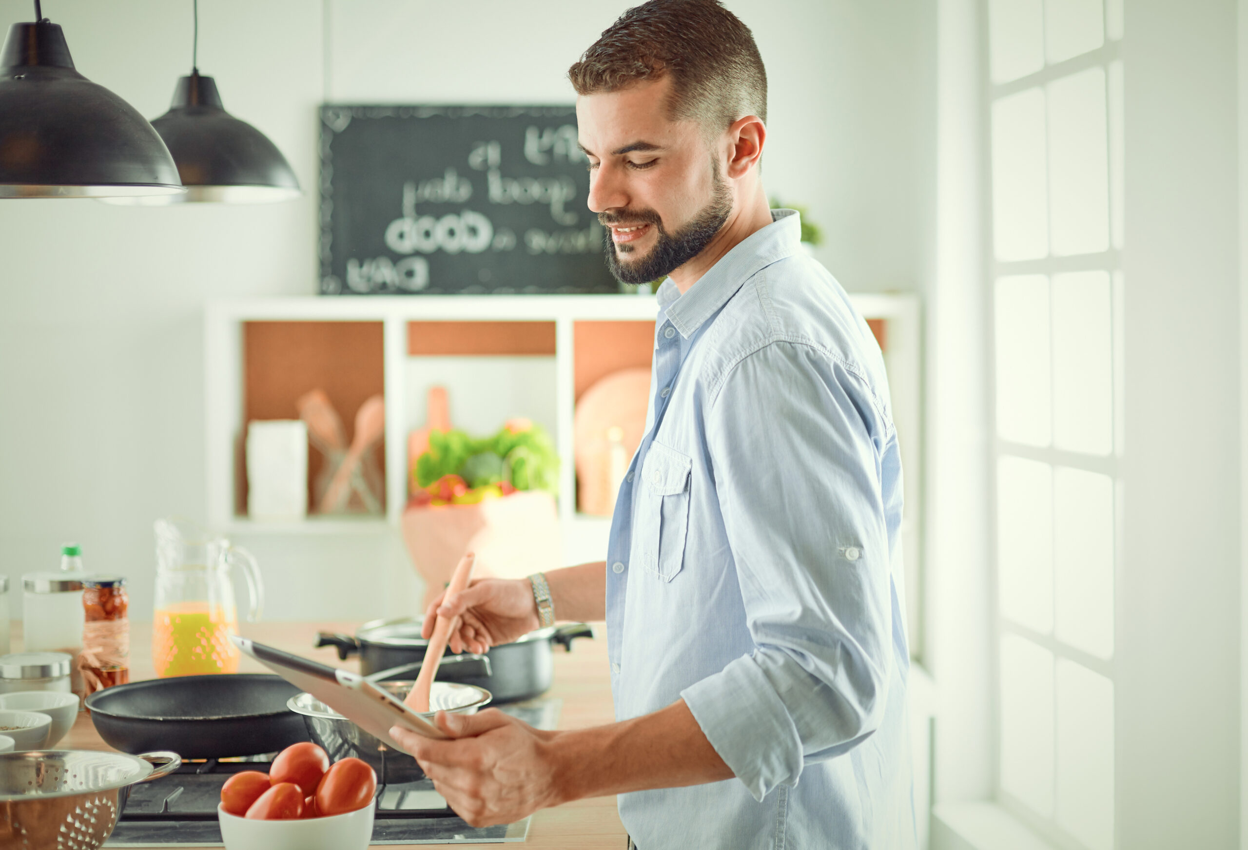 Smiling man cooking dinner in kitchen