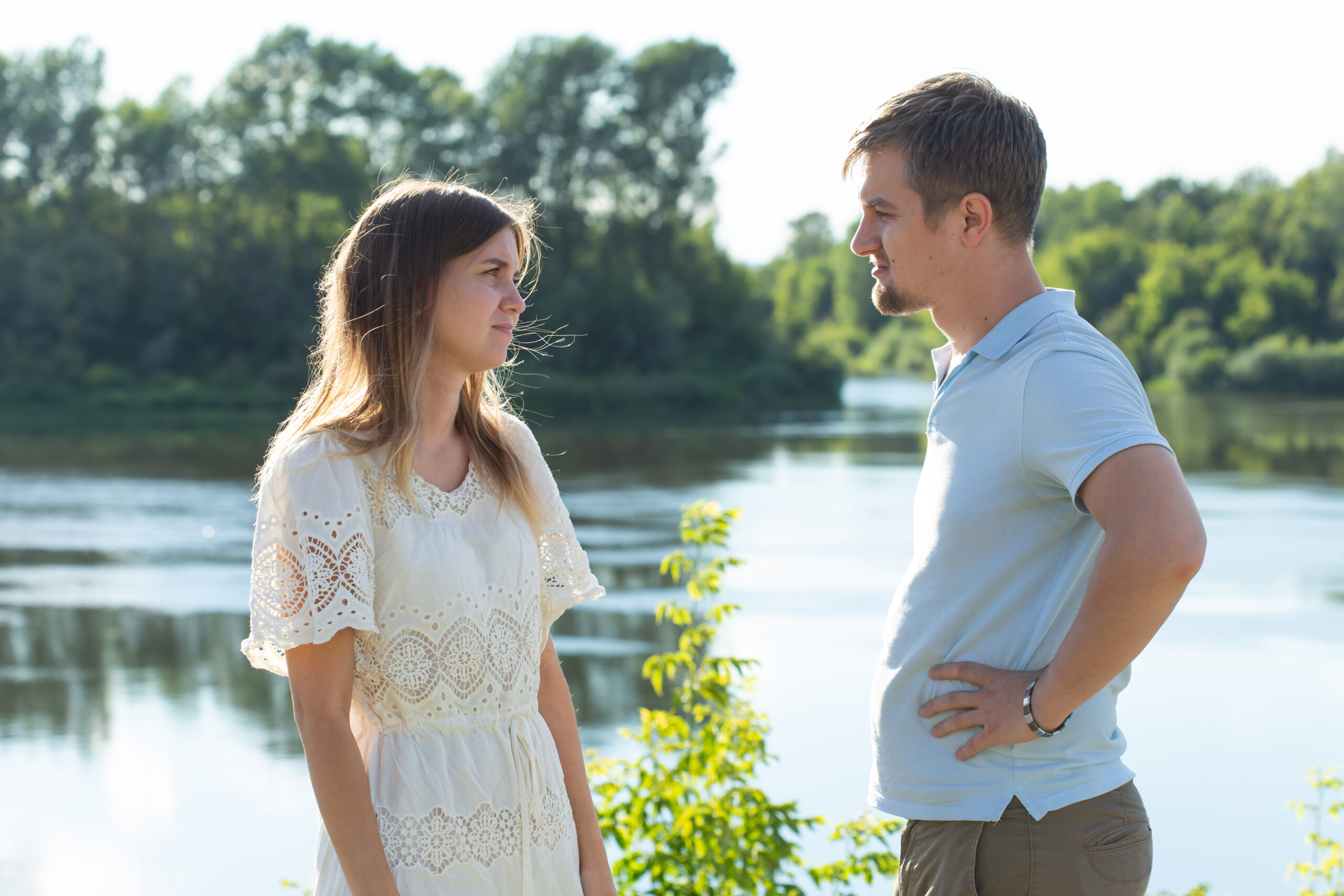 Couple having serious conversation outside by water