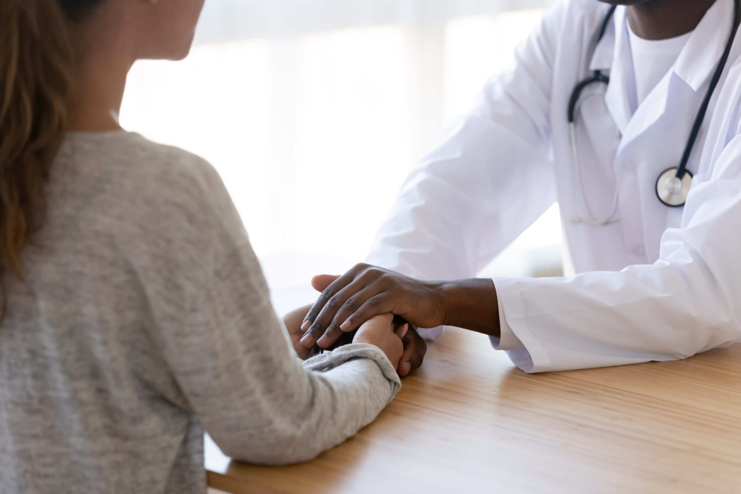 Close up of biracial doctor show support to female patient