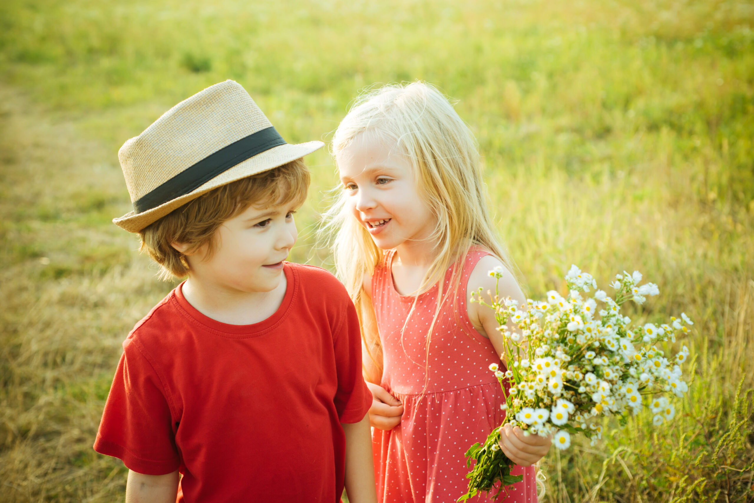 Little boy and girl in grassy field