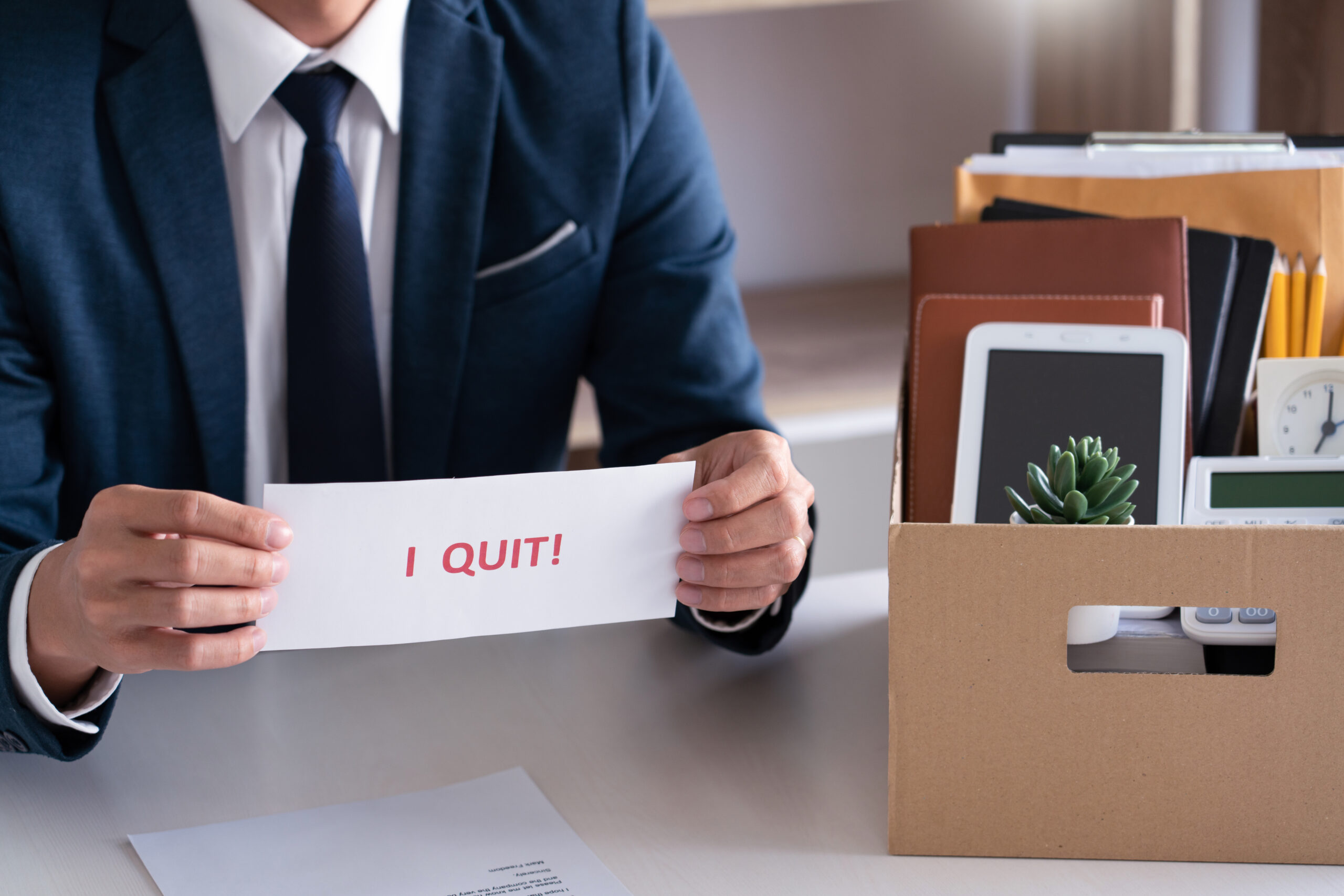 Businessman holding with I quit words card letter, resign employ