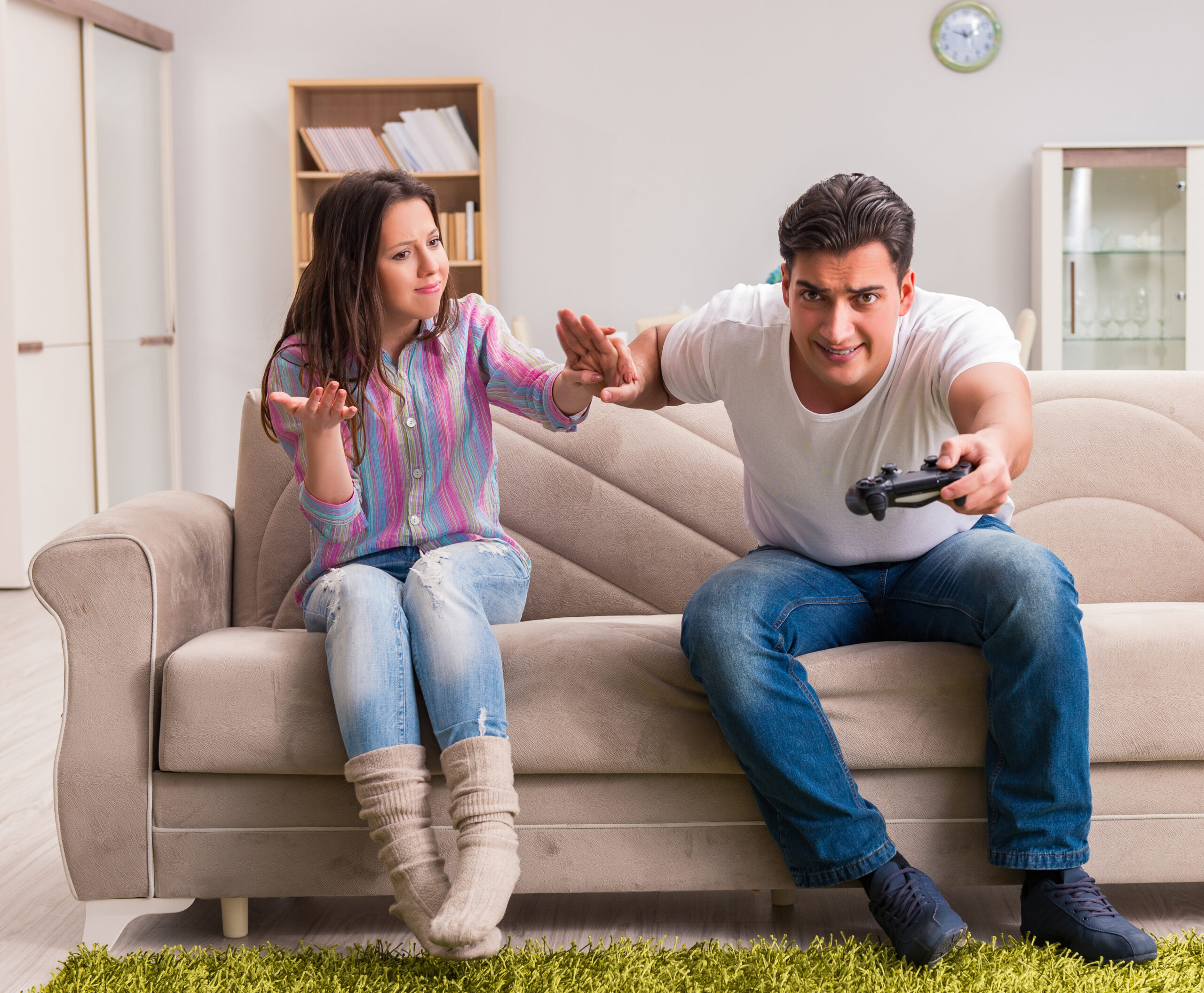 Young couple having a playful argument over video games