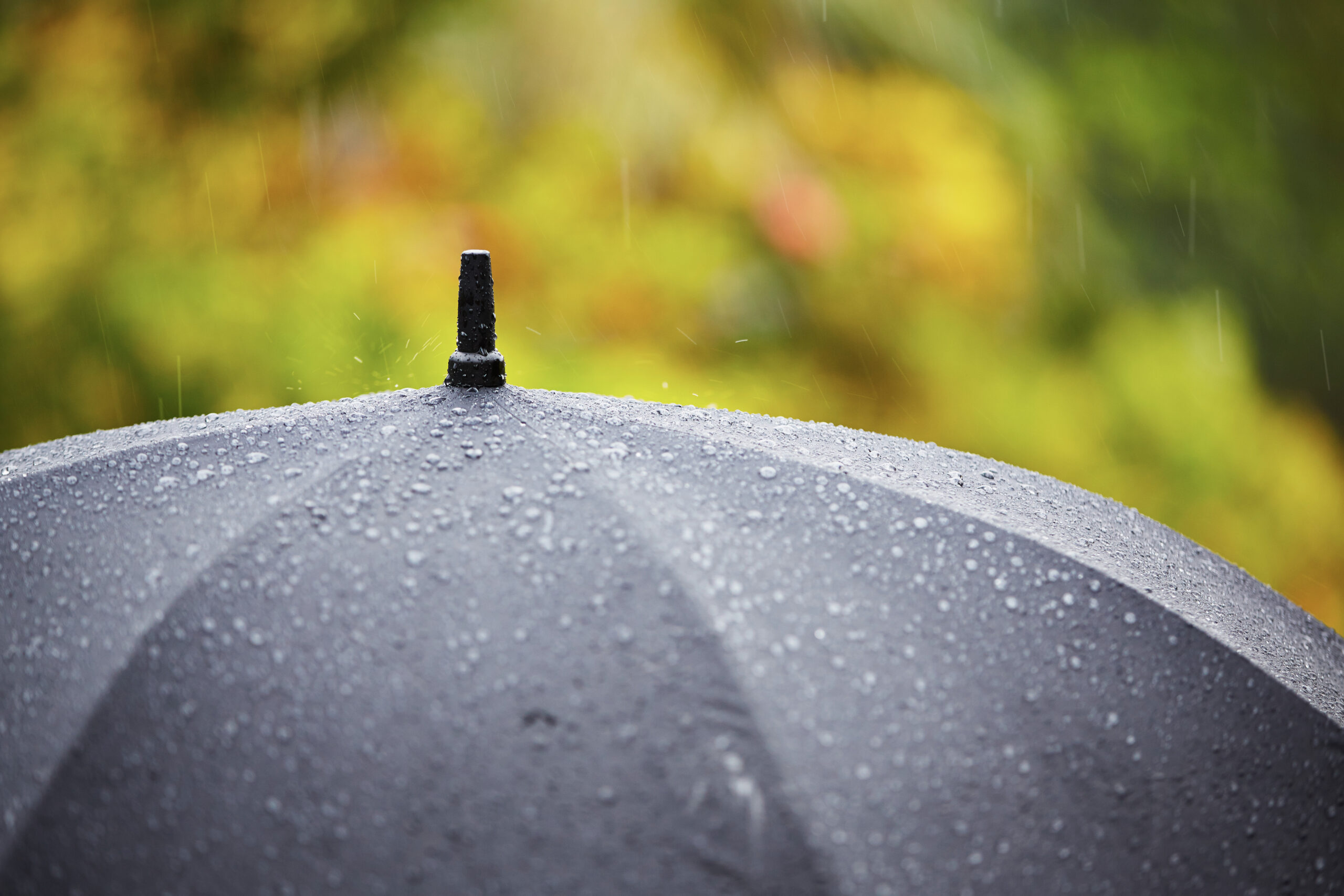 Black umbrella in heavy rain - selective focus