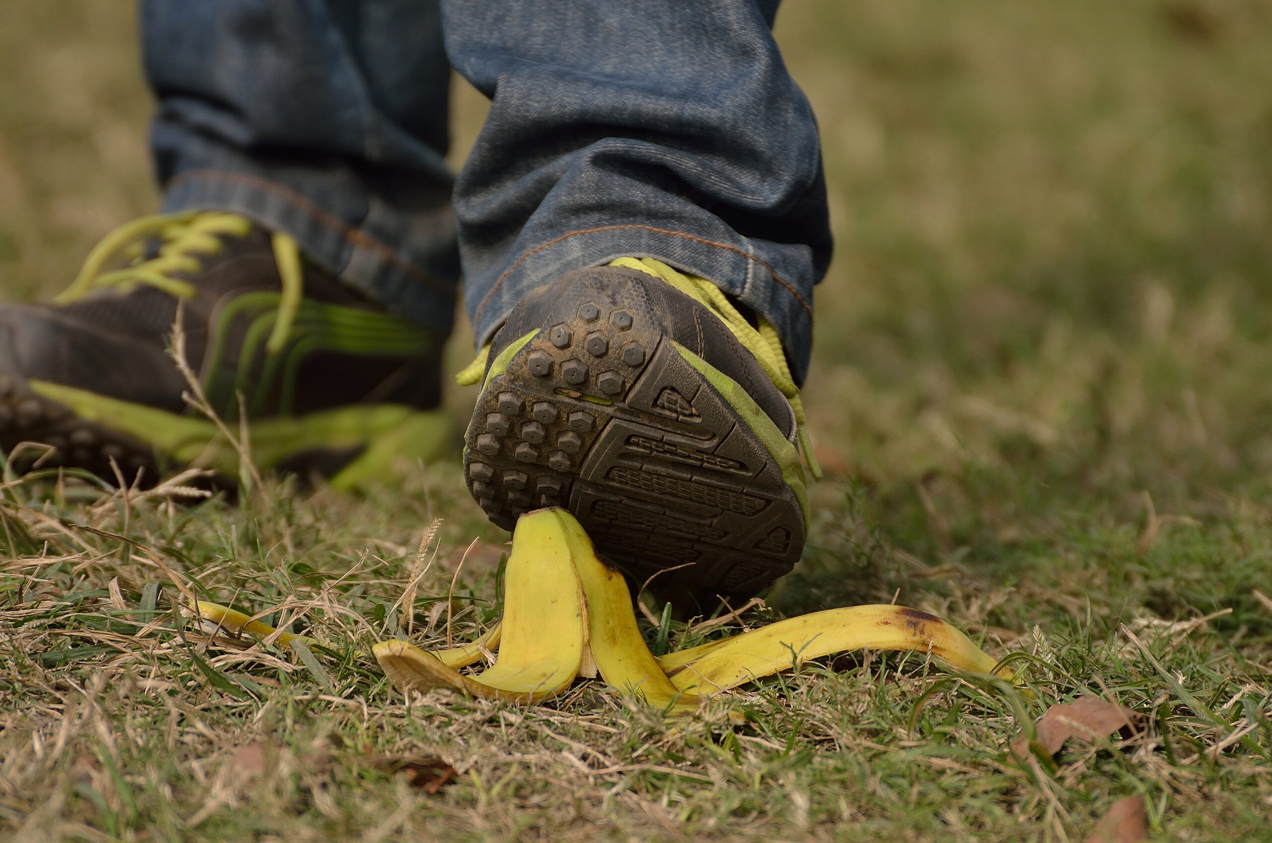 Man foot about to slip and fall on a banana skin.