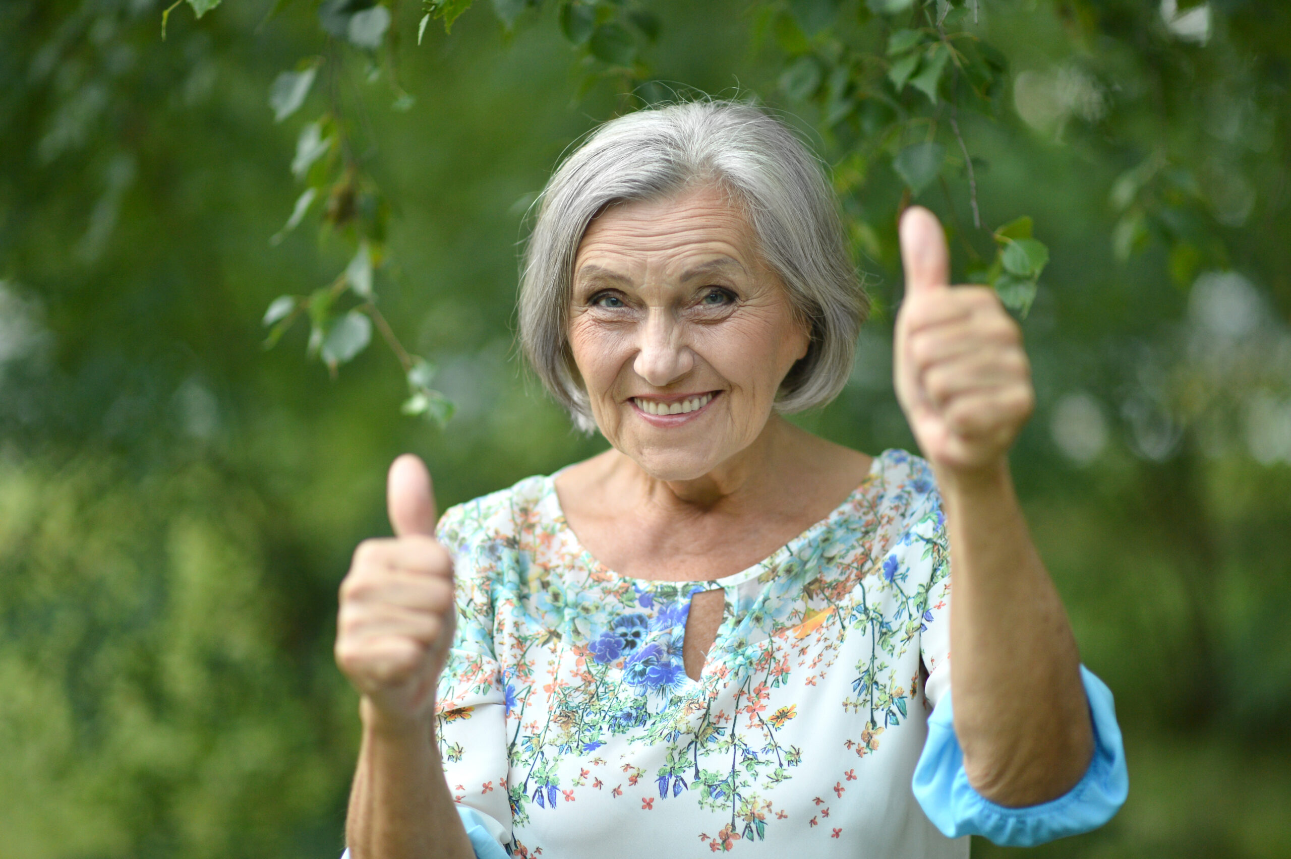 Senior woman with two thumbs up