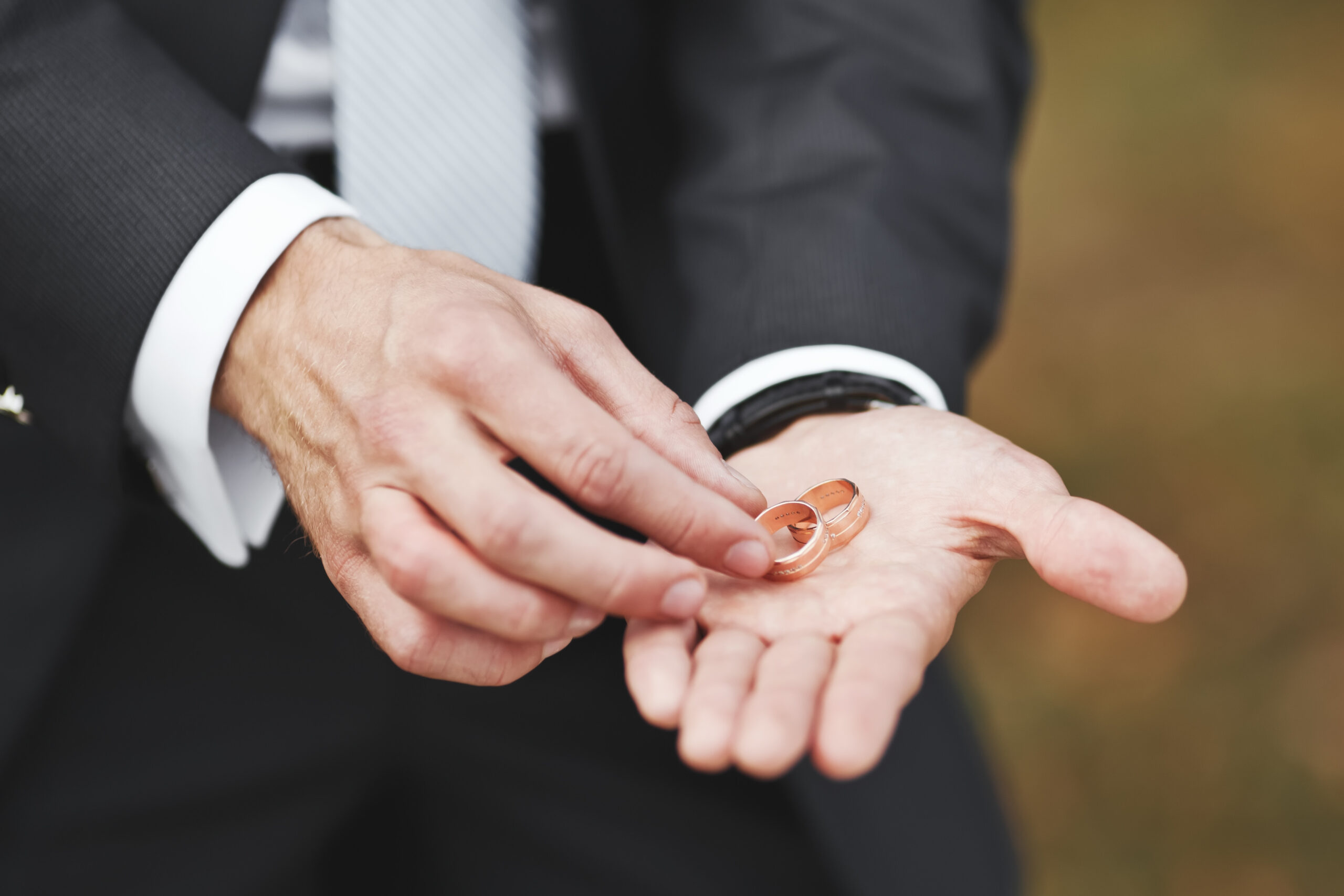 Groom holding wedding golden rings