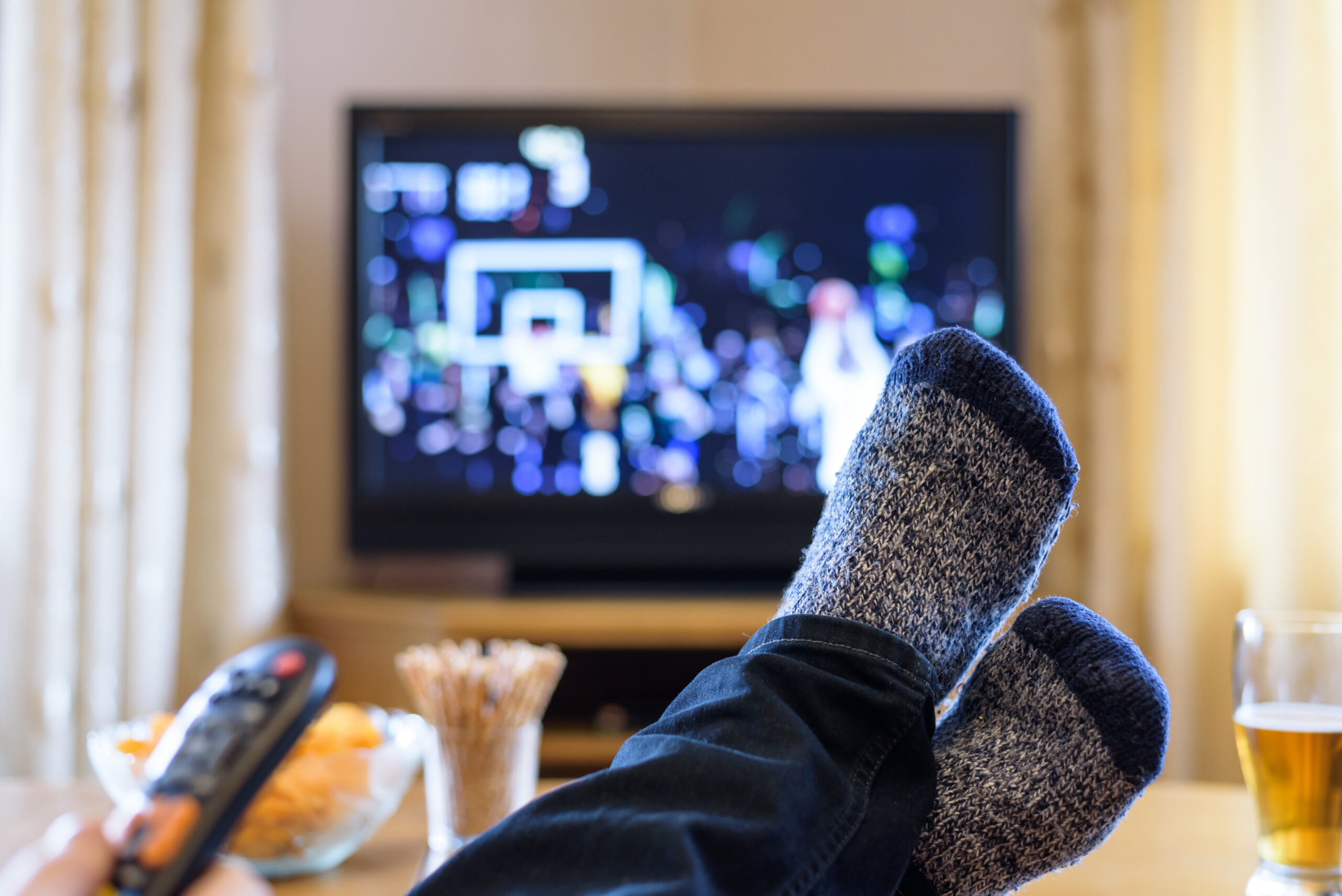 Guy with feet on table watching TV