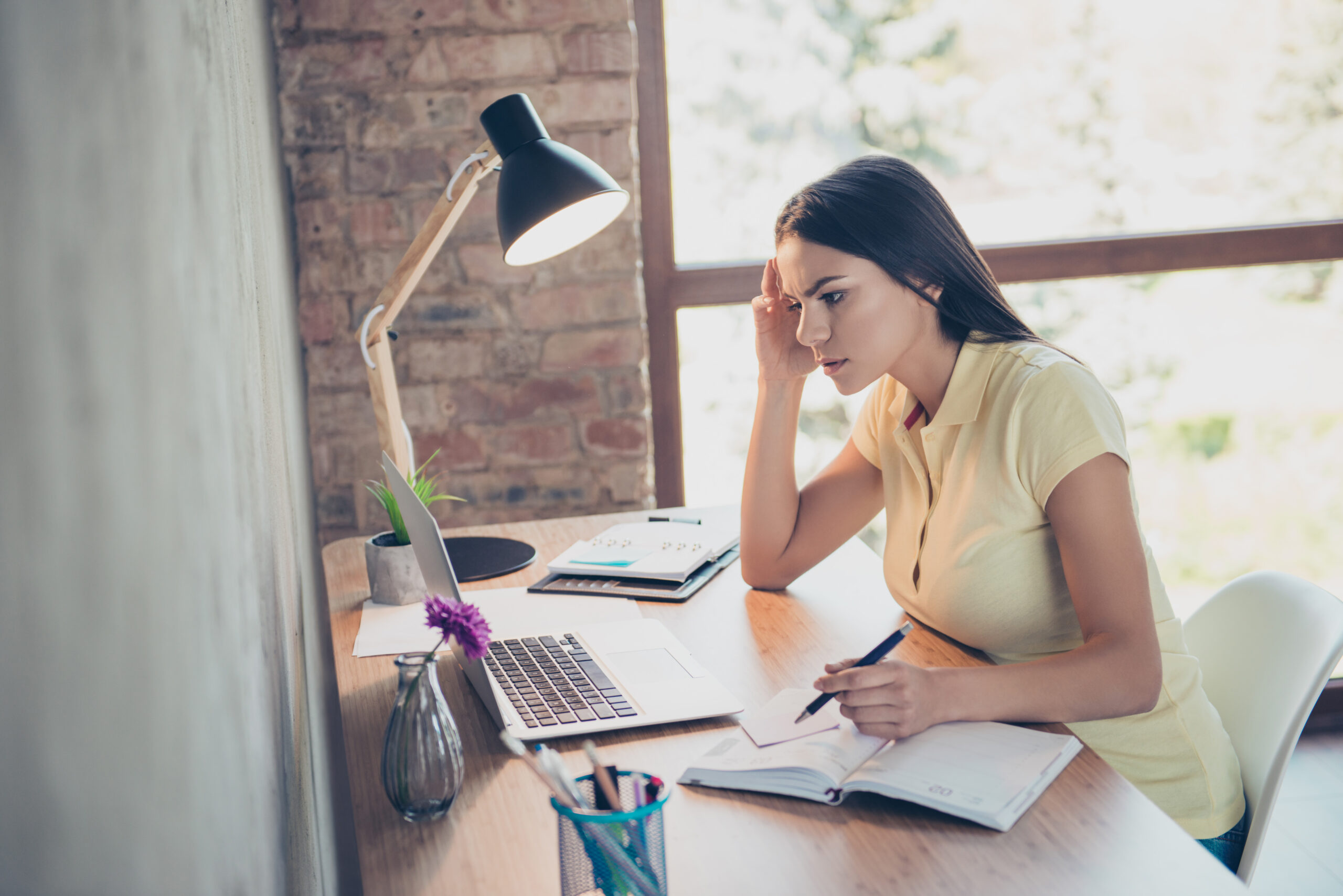 Young woman working hard at desk