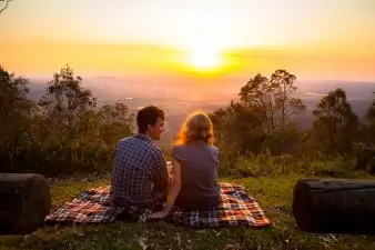 couple on picnic at sunset