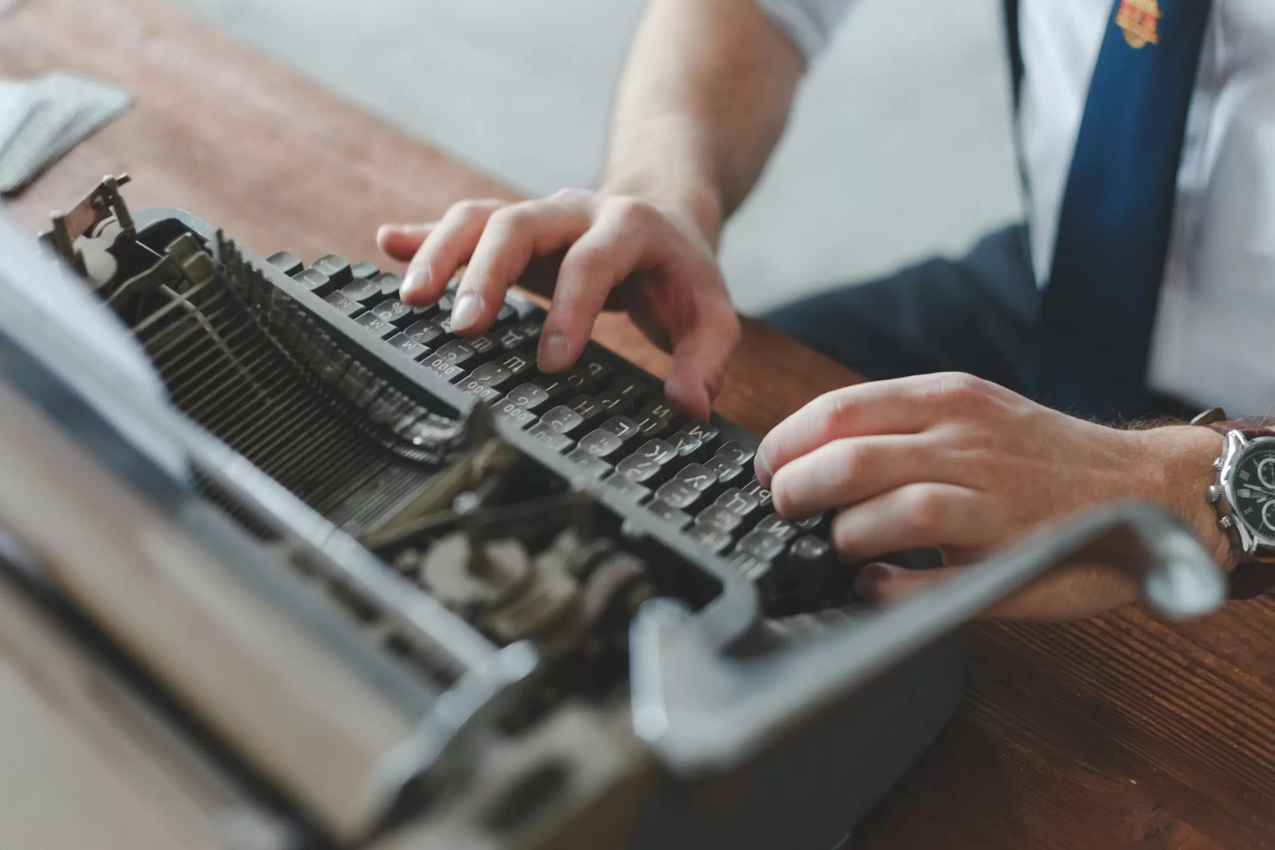 man typing on typewriter