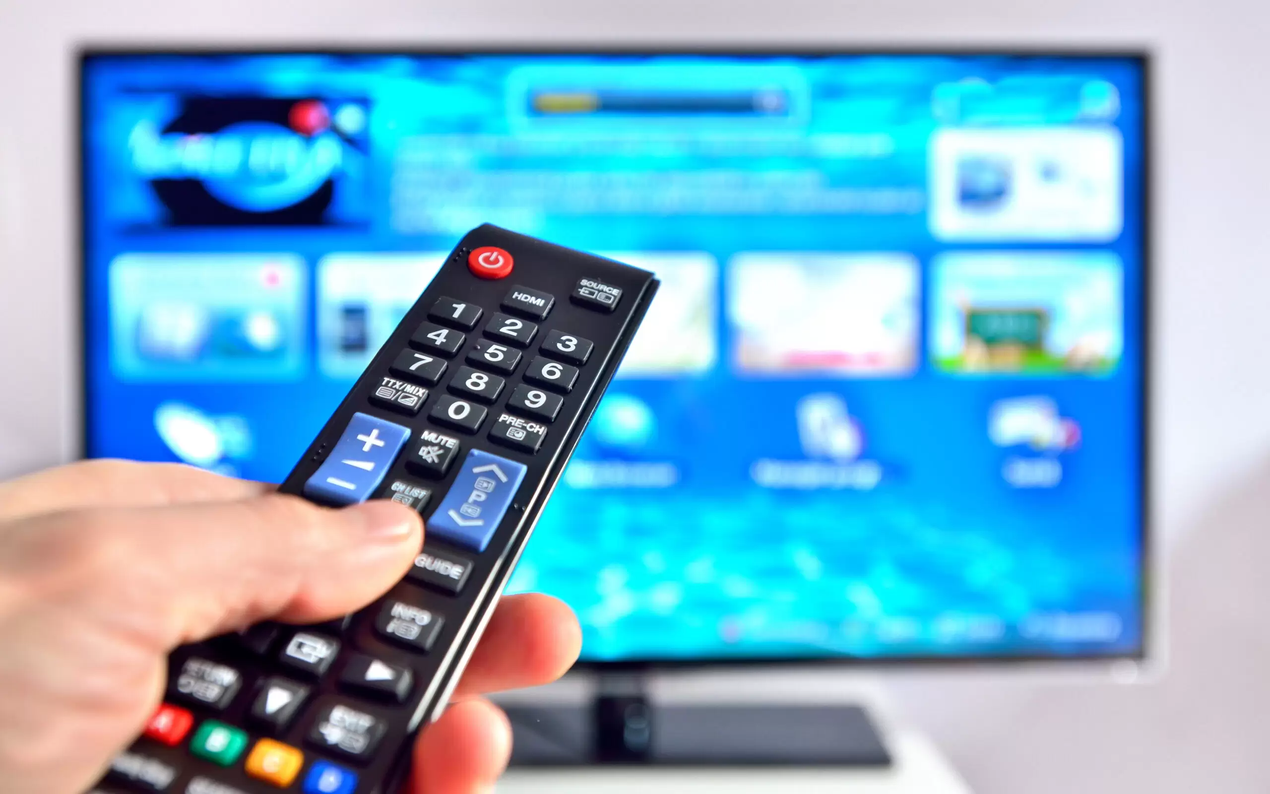 Smart tv and hand pressing remote control