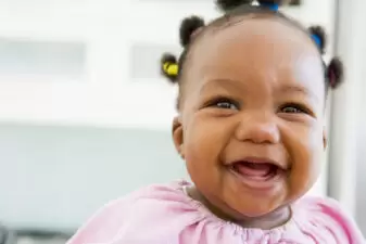 Baby indoors laughing