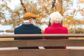 senior couple on bench in park