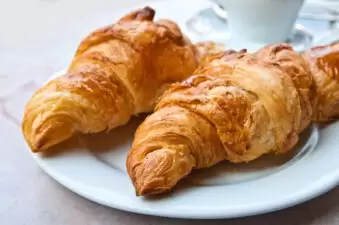 Two croissants on white plate