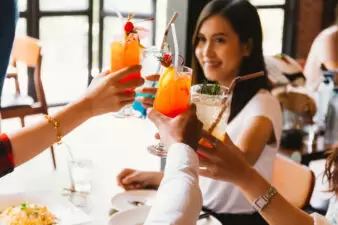 women doing cheers with drinks