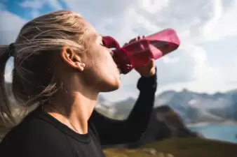 woman drinking from a bottle of water