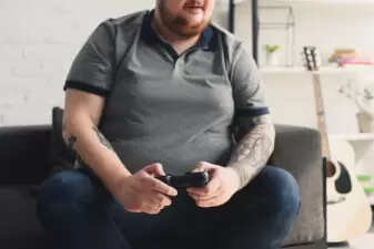 fat man playing video games