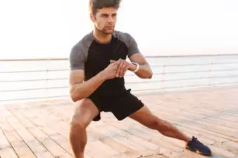 Man doing side lunges