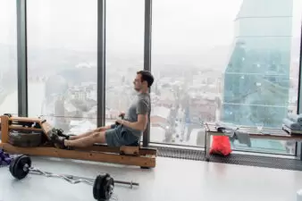 Man working out on row machine in fitness studio