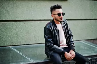 Stylish man wearing leather jacket and sunglasses