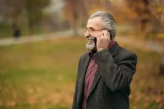 Elderly man on the phone outside