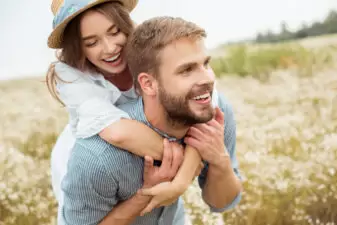 happy couple giving a piggyback ride