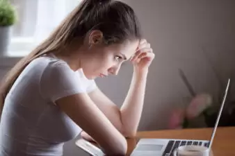 Concerned woman looking at a laptop