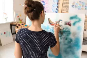 Woman painting canvas in her workshop