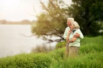 loving older couple outside looking at the water