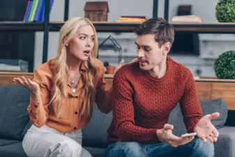 couple arguing on the couch