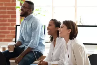 Three people listening to someone talk