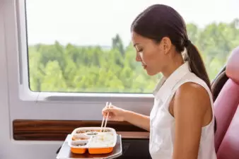 Woman eating food on train