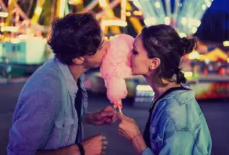 Couple eating cotton candy together