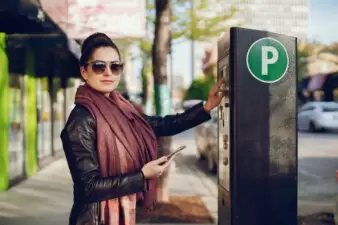 woman pays for Parking