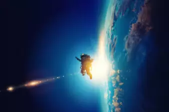 spaceman floating outside of Earth