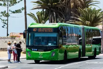 green bus picking up passengers