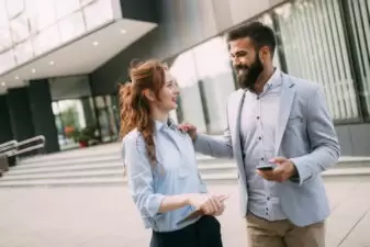 Business man touching the shoulder of a business woman