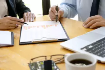 Businessmen discussing paperwork on a desk