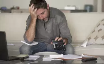 Stressed man looking over his finances