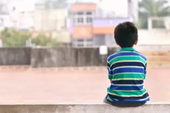 little boy sitting at the park