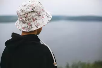 back view of teenage boy wearing a floral bucket hat