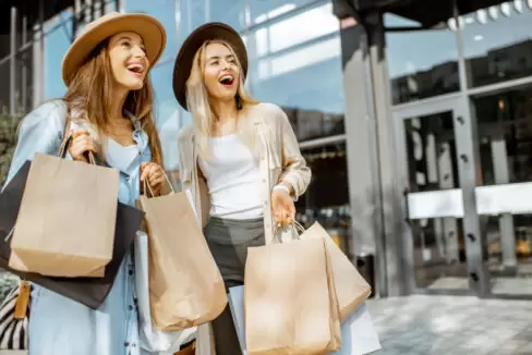 happy women with shopping bags