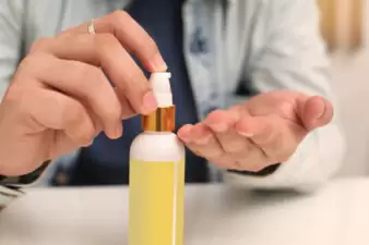 Man spraying soap on hands